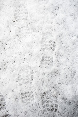 Footprints of human shoes in melting snow