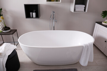 Fototapeta na wymiar Stylish bathroom interior with modern white tub