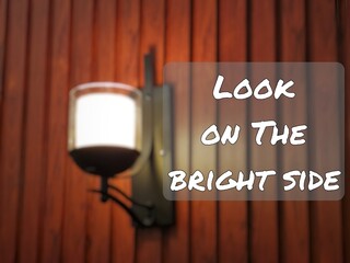 Phrase look on the bright side with blurry vintage wall lamp. - Powered by Adobe