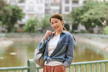 Fototapeta premium Young beautiful woman travels and walks around the city