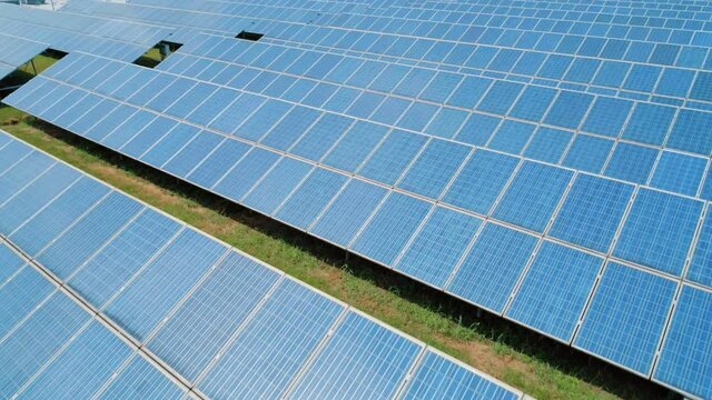 Aerial view of Solar Panels Farm solar cell. Renewable green alternative energy concept. Camera moves forward