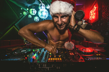 Fototapeta na wymiar DJ Santa mixing up some Christmas cheer. Disco light around fun, colorful atmosphere.