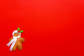 Gingerbread man on a red background. Holiday concept. Christmas background