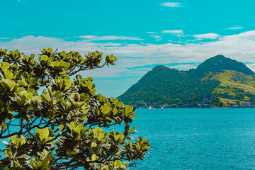 Rio de Janeiro, Brazil - CIRCA 2021: Coastal region of ocean beach during the day with sea, sand...