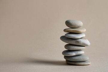 Stack of stones on beige background, space for text. Harmony and balance concept
