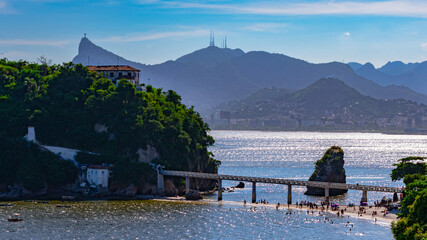 Rio de Janeiro, Brazil - CIRCA 2021: Coastal region of ocean beach during the day with sea, sand and rocks © @renatopmeireles