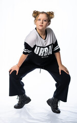 girl in the studio posing. model poses, in a tracksuit. street, youth style. isolated, white background. beauty concept. modern fashion