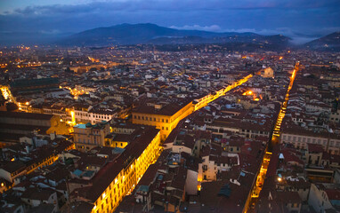 Fototapeta na wymiar Lit up streets during dusk in Italy