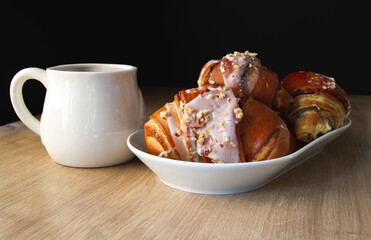 Fresh traditional polish pastry with poppy-seed filling and nuts. St. Martin's croissant or Rogal świętomarciński. With a large mug of tea or coffee.