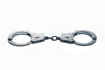 Metal handcuffs on a white isolated background