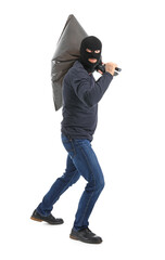 Male burglar with flashlight and bag on white background