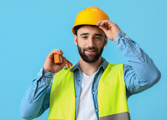 Construction worker with builder level on blue background