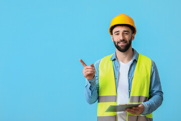 Construction worker with clipboard pointing at something on blue background