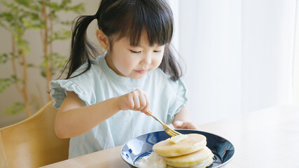 ホットケーキを食べる4歳の子供（育児・子育て）