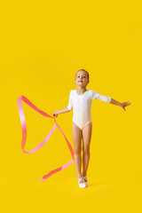 Little girl doing gymnastics with ribbon on color background