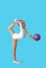 Fototapeta na wymiar Little girl doing gymnastics with ball on color background