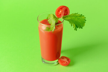 Glass of bloody mary with celery and tomato on color background