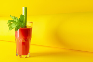 Glass of bloody mary with celery on color background © Pixel-Shot