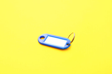 Plastic key tag on yellow background