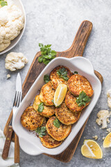 Vegan cauliflower vegetable fritters on the kitchen table. Fried vegetarian cutlets or pancakes. The concept of fast food.