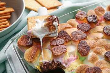 Baking dish with tasty S'mores dip on table, closeup