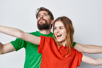 Fototapeta premium man and woman multicolored t-shirts communication quarrel light background