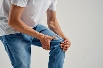 Man sitting on chair knee pain health problems