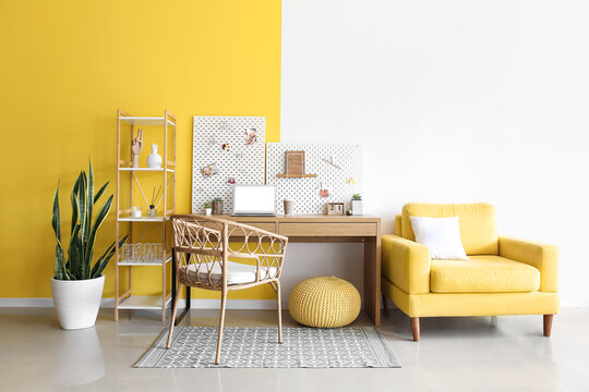 Stylish Workplace With Peg Board On Yellow And White Wall Background