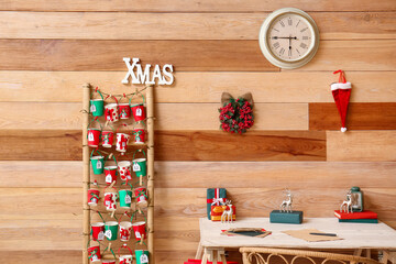 Obraz na płótnie Canvas Modern workplace and advent calendar in room decorated for Christmas