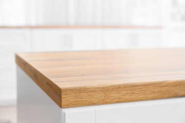 Wooden table top in modern kitchen, closeup
