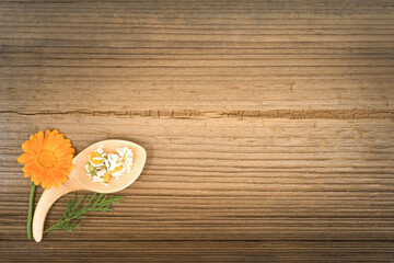 Medicinal herbs on a wooden background