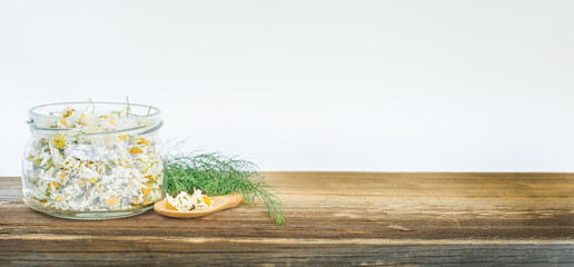 Dried chamomile in a jar on the table