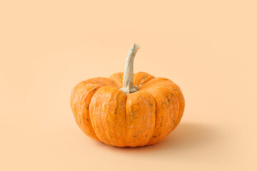 Whole fresh pumpkin on beige background