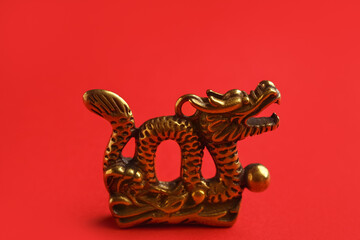 Fototapeta premium Figurine of Chinese dragon on color background