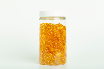 Fish oil in gelatin capsules isolate. Omega vitamins in golden colored pills on a blank white background. Medicine, pharmacy, drugs and multivitamins oils concept
