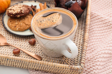 Cup of tasty pumpkin coffee on fabric background