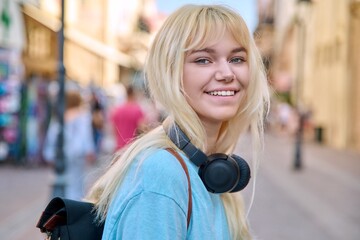 Fototapeta premium Outdoor portrait of a happy smiling teenage girl 17 years old