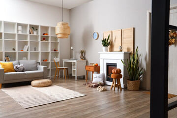 Interior of living room with autumn decor and fireplace