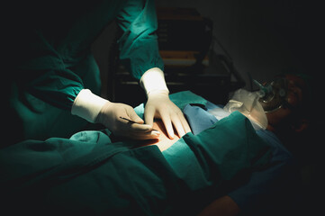 Team of doctors wearing protective clothing works together to monitor patients in Bright Modern operating room. Surgery on patients lying on patient beds. resuscitation of the wounded.