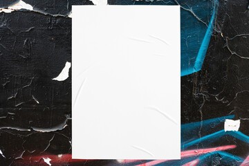 Closeup of colorful messy painted urban wall texture with wrinkled glued poster template . Modern...