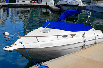 Fototapeta na wymiar Small luxury motor boat parked at the pier