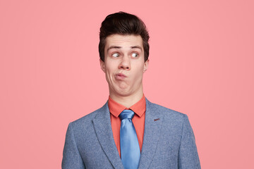 Funny uncertain businessman hesitating in studio