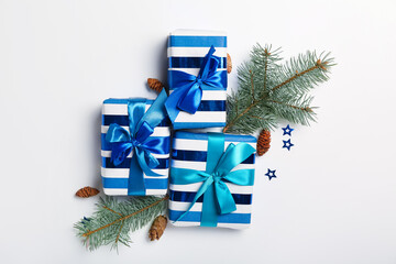 Christmas composition with gift boxes and fir branches on light background