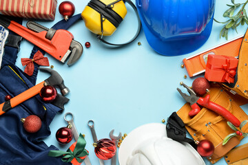 Frame made of construction tools and Christmas decor on color background