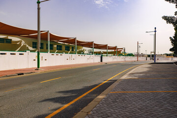 Asphalt road with modern city skyline of Dubai.