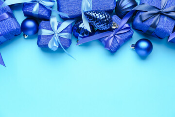 Beautiful Christmas gifts with decor on blue background