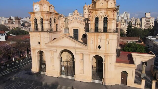 Aerial tilt up shot, drone flying toward cathedral of Cordoba in Plaza San Mart&iacute;n, capturing the close up exterior details of historical baroque style architecture.
