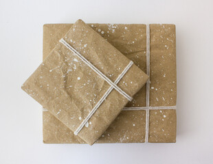 Gift boxes wrapped in beige craft paper and tied with white cotton thread. The concept of New...