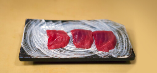 Tuna sashimi served on ceramic plate. Enjoy Omakase experience at Japanese Sushi Restaurant.