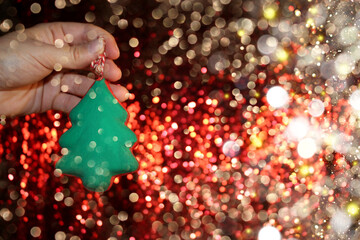 beautiful green Christmas tree is lying on your hand on a shiny background